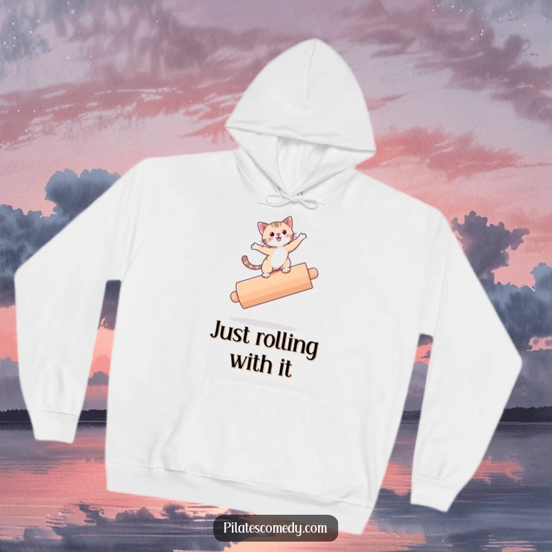 Funny cat design on a cozy hoodie, cat is precariously balancing on a large roller, perfect for cat lovers.